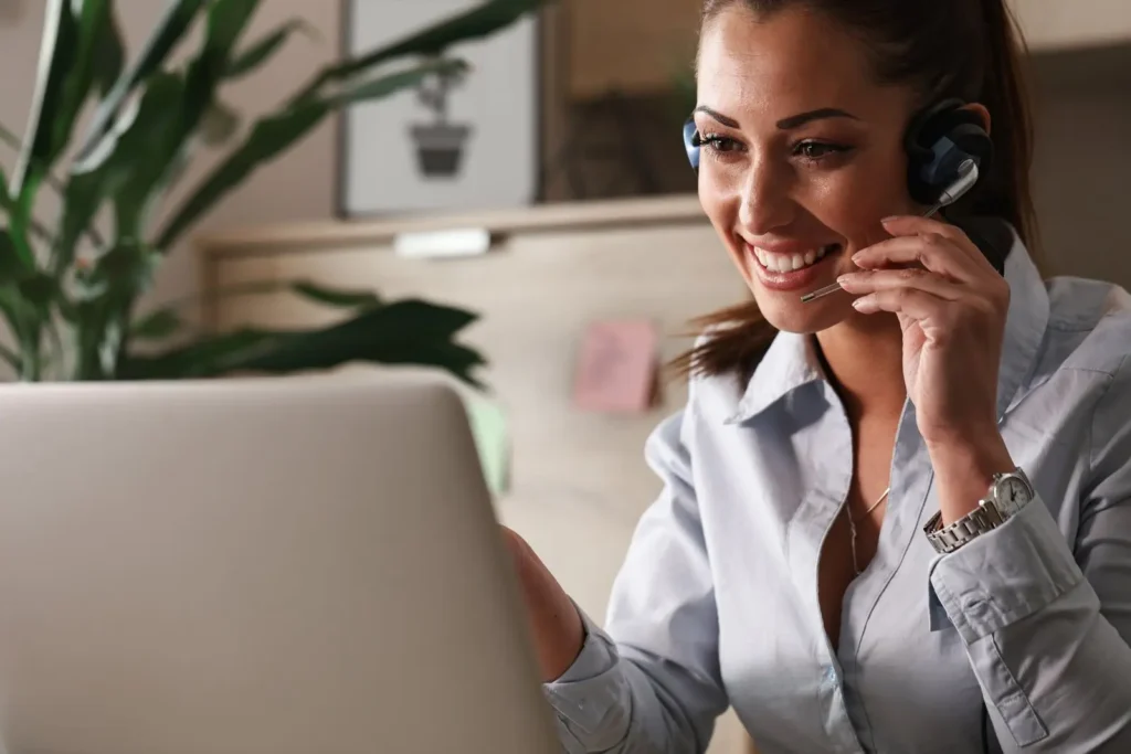 Loans Connecticut - happy customer service representative talking with customer while using laptop office